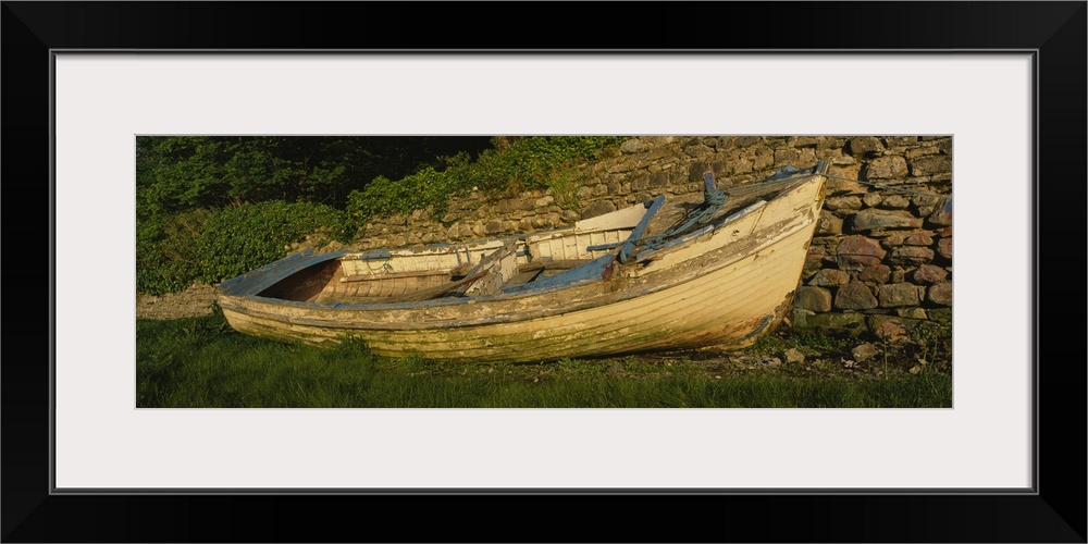 Old fishing boat in front of a stone wall, Westport, County Mayo, Republic of Ireland