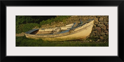 Old fishing boat in front of a stone wall, Westport, County Mayo, Republic of Ireland