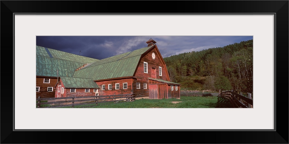 Old red barn with green rooftops in a farm, Vermont,