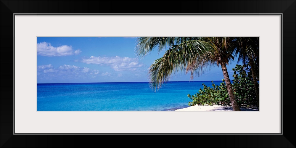 Wall art for the home or office this panoramic photograph captures a still sea with minimal clouds floating in the distant...
