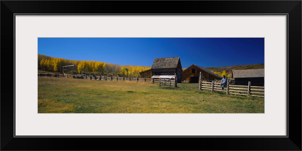 Person sitting on a fence, Last Dollar Ranch, Colorado