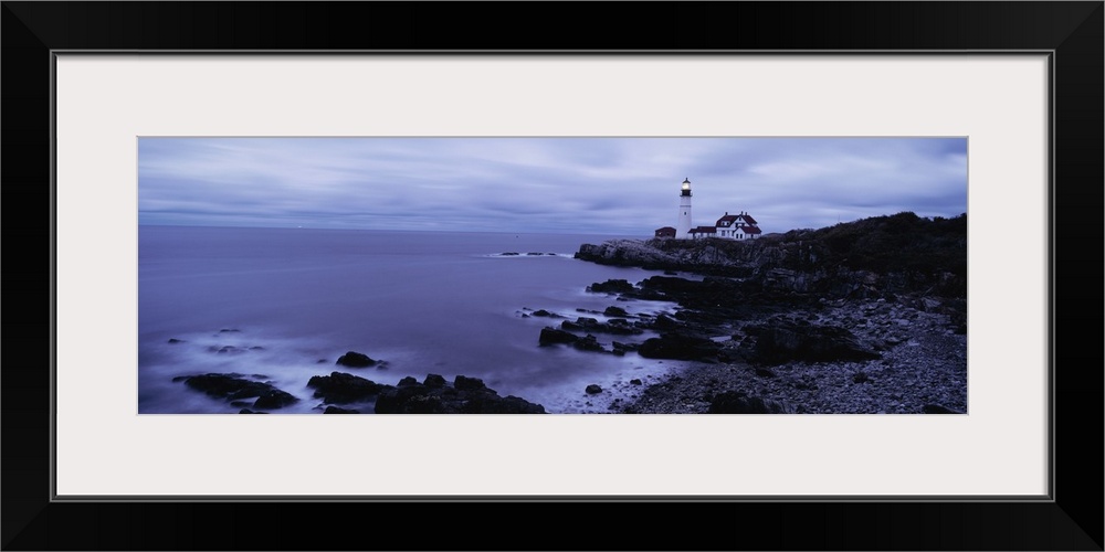 Wide angle photograph on a large canvas of the shoreline at Cape Elizabeth, Maine, Portland Head Light in the distance, be...