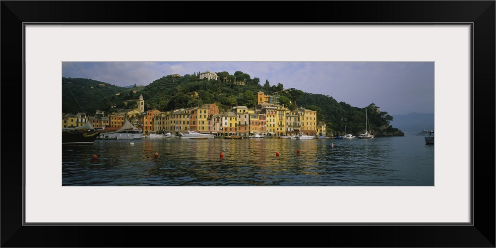 This is a panoramic photograph of the picturesque harbor taken from on the water.