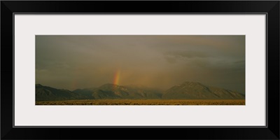Rainbow in a cloudy sky, Taos, New Mexico