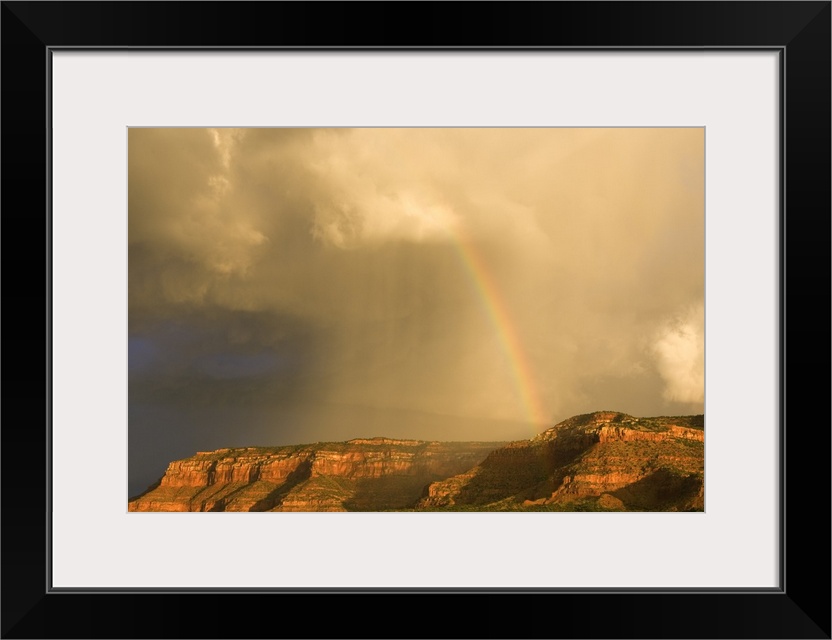 Rainbow Over Desert Landscape With Mesas