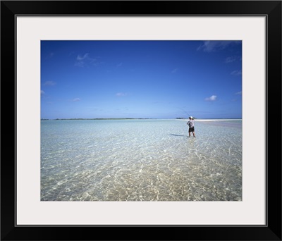 Rear view of a man fishing in the ocean, Tuamotu Archipelago, French Polynesia
