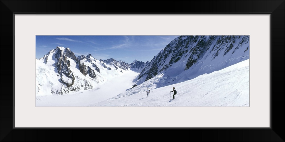 Rear view of two people skiing, Les Grands Montets, Chamonix, France