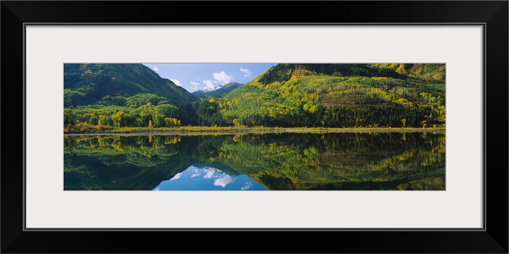 Reflection of mountains and aspen trees in water near Marble, Colorado