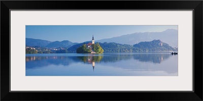 Reflection of mountains and buildings in water, Lake Bled, Slovenia