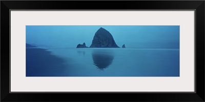 Reflection of rock in water, Haystack Rock, Cannon Beach, Clatsop County, Oregon