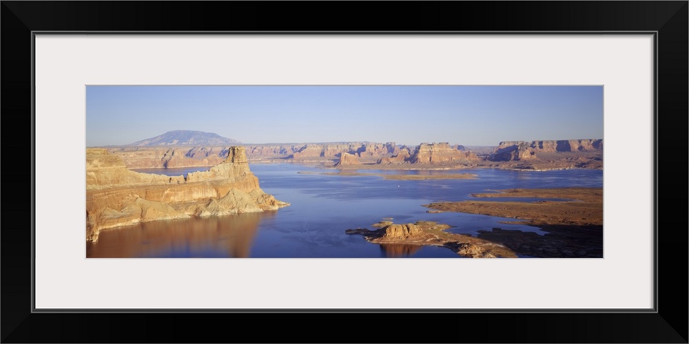 Panoramic photograph of huge rocks and canyons in river under a clear sky.