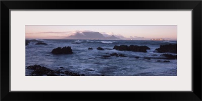 Rocks in the sea with Table Mountain in the background, Bloubergstrand, Table Mountain, Cape Town, Western Cape Province, Republic of South Africa