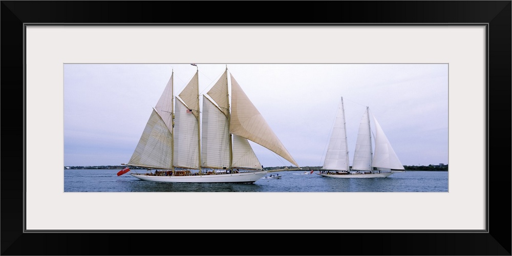Panoramic canvas photo of two big sailboats in a bay.