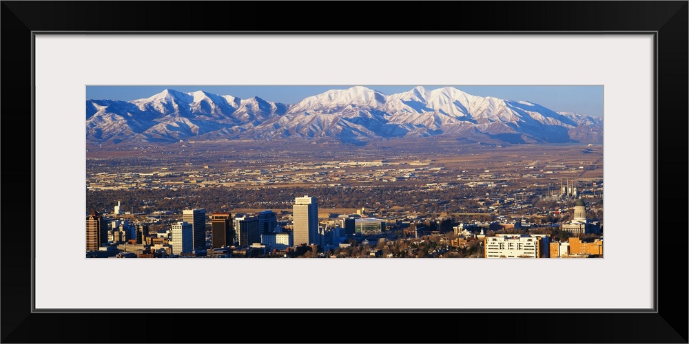 This panorama features the contrasting terrain of Salt Lake City, Utah and mountain peaks.