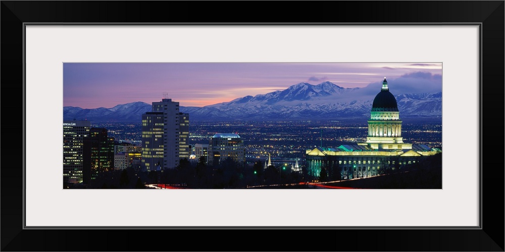 Panoramic Rocky Mountains and downtown Salt Lake City, Utah as the last of the sun dips below the mountains.