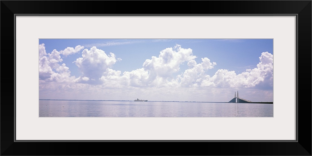 Sea with a container ship and a suspension bridge in distant, Sunshine Skyway Bridge, Tampa Bay, Gulf of Mexico, Florida,