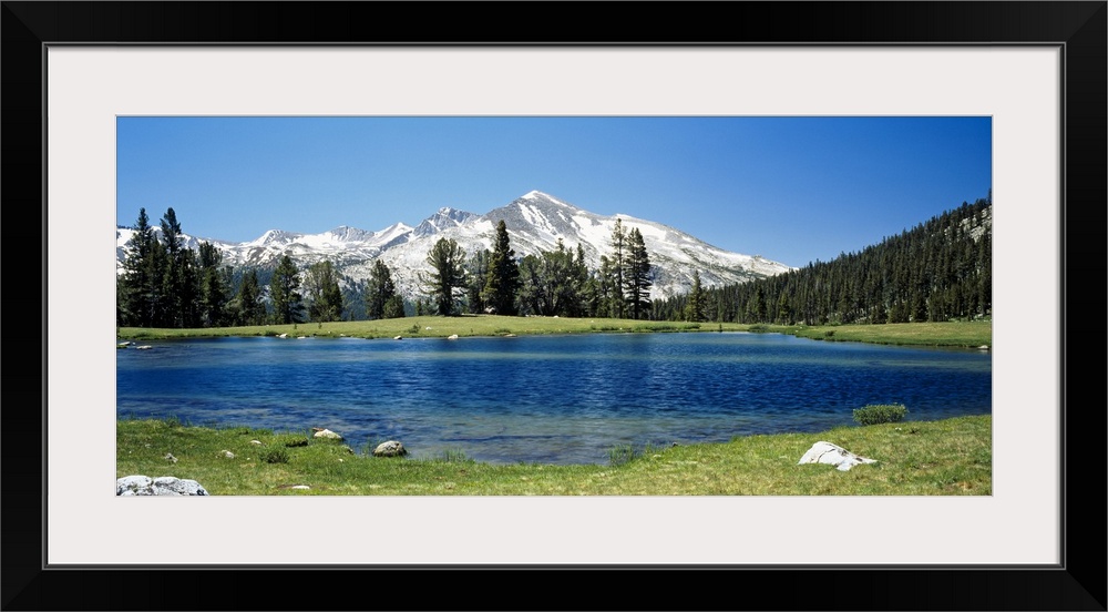 Big canvas photo of a lake with snow covered mountains in the distance.