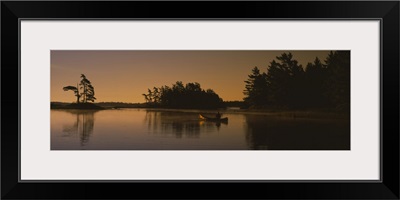 Silhouette of a person in a canoe on a lake, Kejimkujik Lake, Kejimkujik National Park, Nova Scotia, Canada