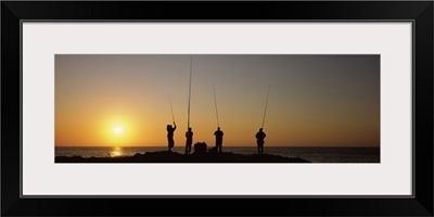 Silhouette of fishermen fishing in river at sunset Scottburgh KwaZulu Natal South Africa