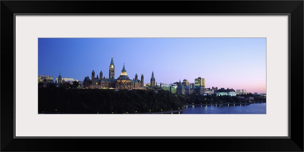 Silhouette of parliament building along a lake, Ottawa, Ontario, Canada