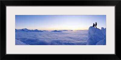 Silhouette of two hikers standing on a mountain peak, Whistler, British Columbia, Canada