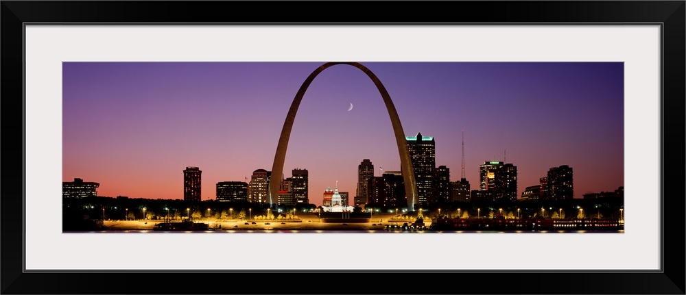 Wide angle view of the St. Louis skyline including the Gateway Arch, at sunset.