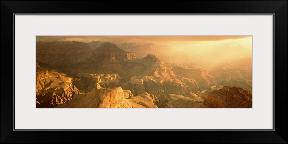 Panoramic photo on canvas of the Grand Canyon bath in warm sunlight from a rising sun.