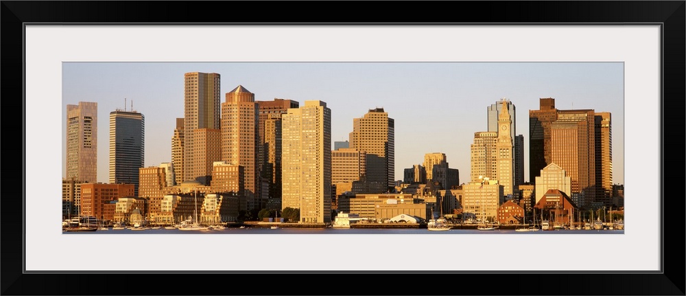 Huge, panoramic photograph of the Boston skyline in the morning sun.