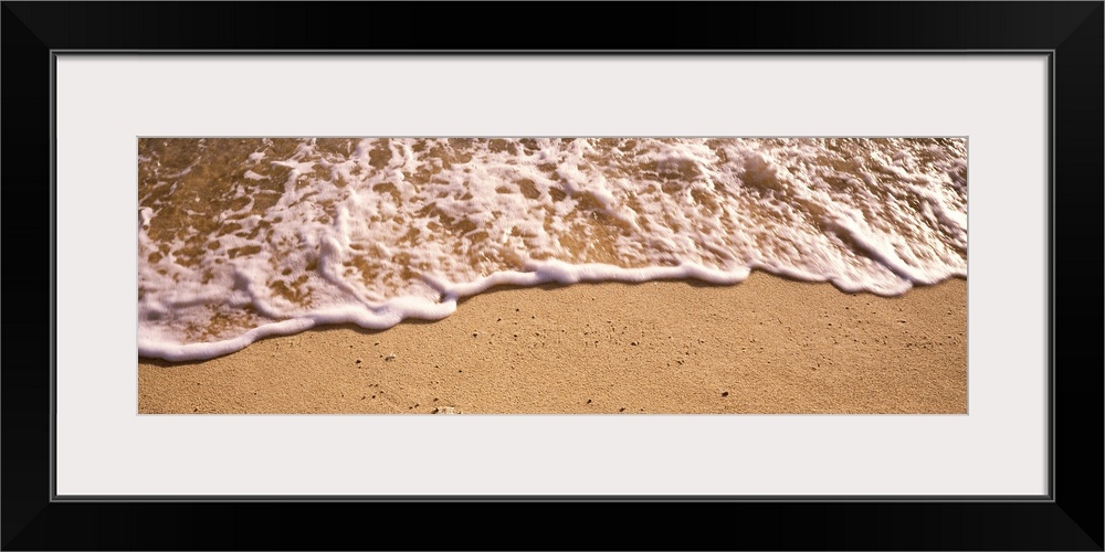 Panoramic photograph of sea spray on shoreline.