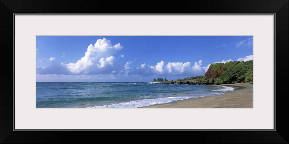 Horizontal photograph on a giant wall hanging of the shoreline along Hamoa Beach, green hills in the background, in Hana, ...