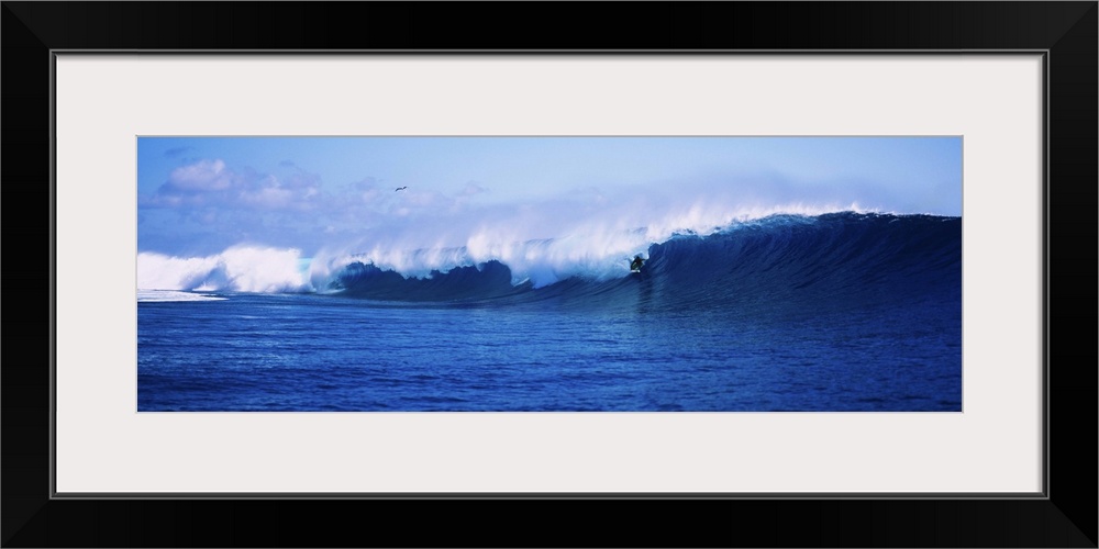 Surfer surfing in the ocean, Tahiti, French Polynesia