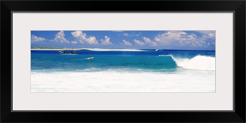 Surfer surfing in the ocean, Tuamotu Archipelago, Tahiti, French Polynesia