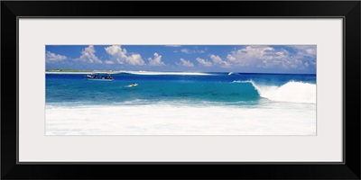 Surfer surfing in the ocean, Tuamotu Archipelago, Tahiti, French Polynesia