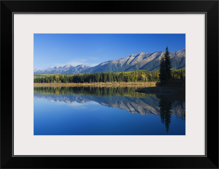 Big canvas photo of mountains and their reflection onto the lake in front of them.