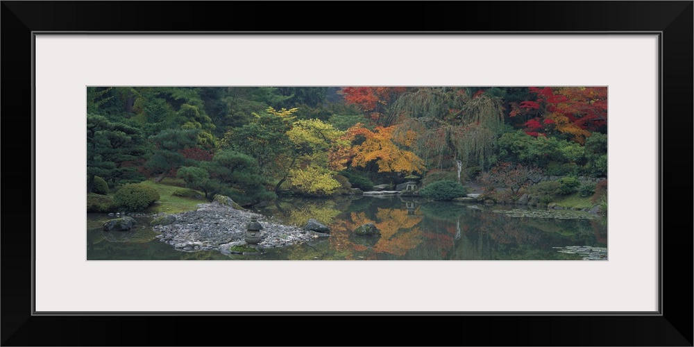 Giant panoramic photo of the Japanese Garden in Seattle, Washington (WA) with trees and stones lining a body of water. Gre...