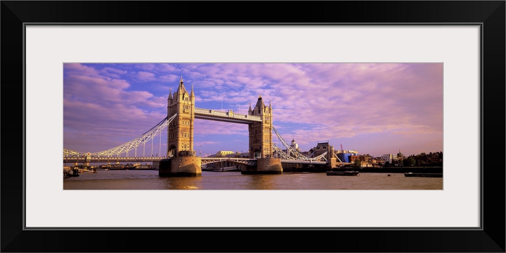 Daytime panorama of London's Tower Bridge, which crosses the River Thames.