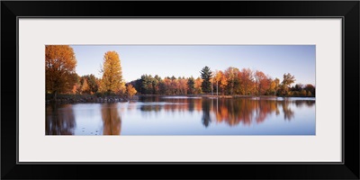 Trees in autumn along a lake, Canterbury, New Hampshire, England