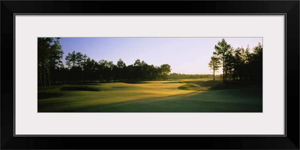 This is a landscape photograph of an empty golf landscape in the morning light.