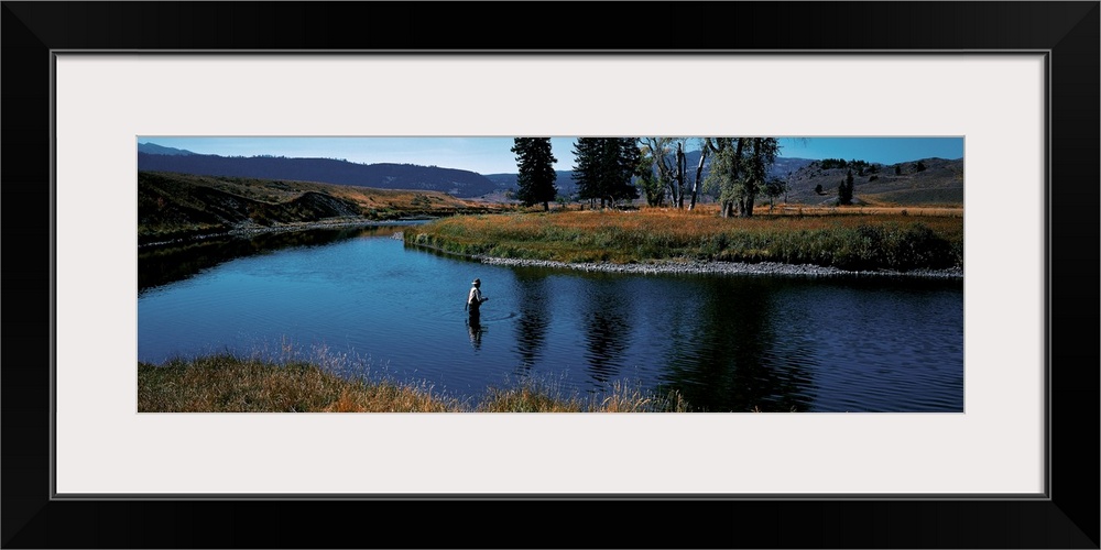 Giant, landscape photograph of Slough Creek in Yellowstone National Park in Wyoming, surrounded by hills and trees.  A lon...