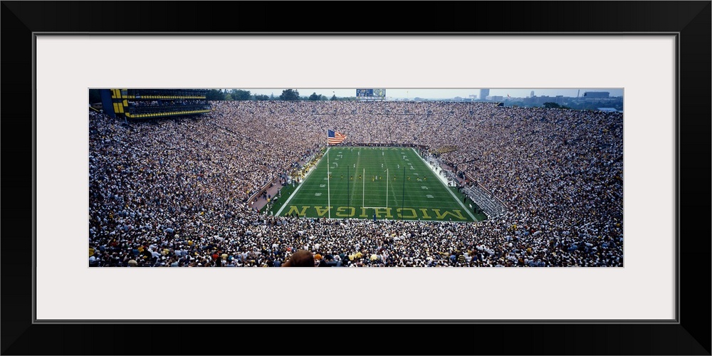 Wide angle, aerial photograph of Michigan Stadium full of fans, during a University of Michigan football game in Ann Arbor.