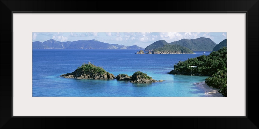 This decorative wall is a panoramic landscape photograph of a small rocky island off the shore of this tropical island.