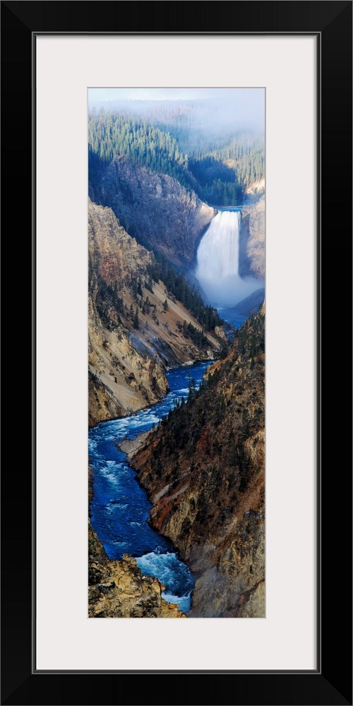 Giant panoramic artwork of a waterfall dumping water into a small river at the bottom of a canyon in Yellowstone National ...