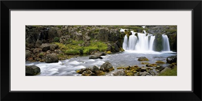 Waterfall on rocky stream, Iceland