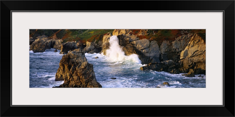 Horizontal photo print of waves crashing into rocky cliffs in the Pacific Ocean and rock formations sticking up out of the...