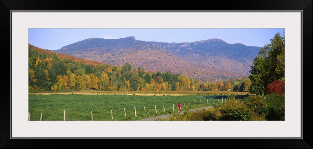 Woman cycling on a road, Stowe, Vermont