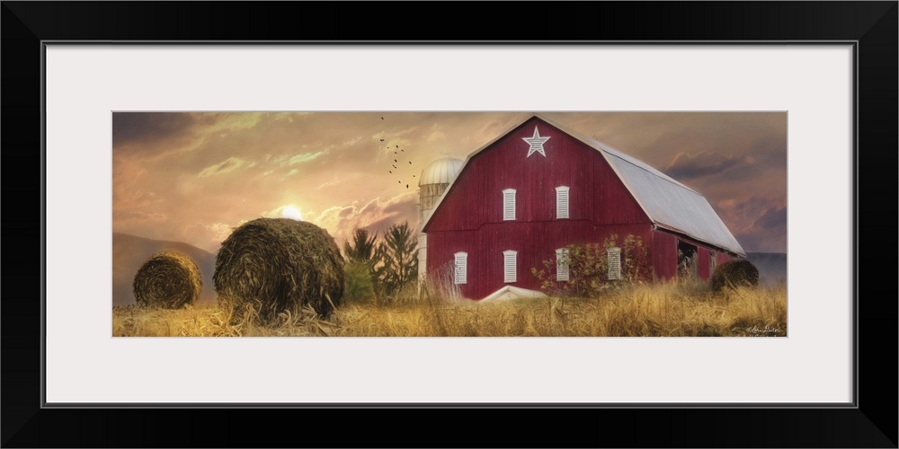 A large red barn in the countryside at sunset.