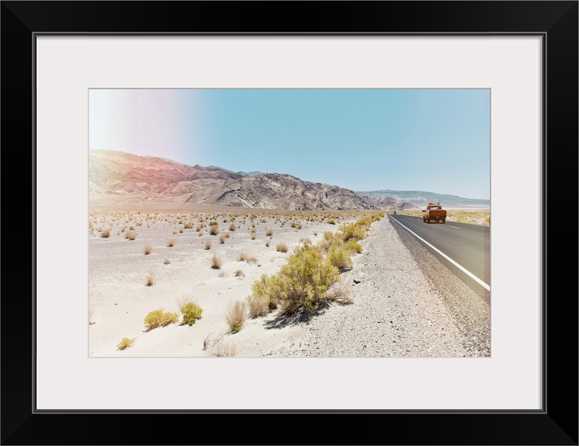 A photograph in soft faded pastel colors of a desert landscape in California.