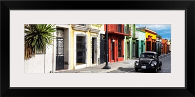 Colorful Mexican Street with Black VW Beetle