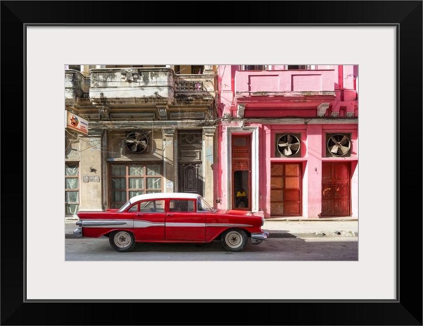 Photograph of a red vintage car with white details parked in the street, Havana, Cuba