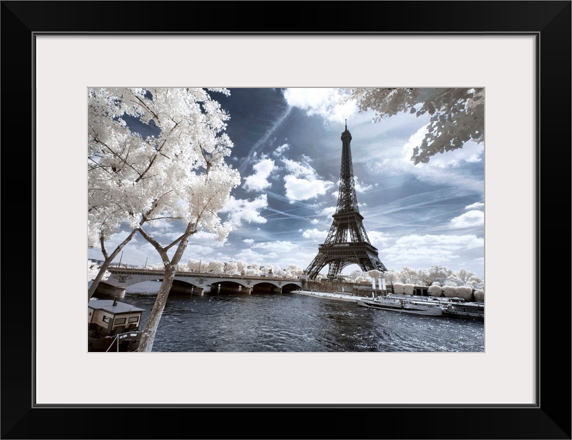 A view of the Eiffel Tower in Paris, made in infrared mode in summer. The vegetation is white and rendering of the sky is ...